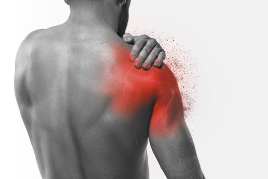 Man with pain in shoulder. Concept of human pain