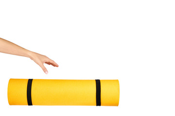 Close up view of yellow yoga mat for exercise with hand, isolated on white background, copy space template.
