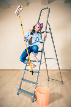 happy little girl on a folding ladder