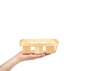 Empty basket for fruits and vegetables with hand isolated on the white background, copy space template.