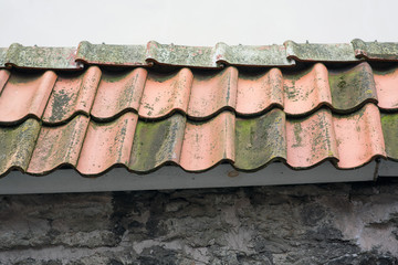 Spanish style ceramic tile roof with blue sky. Background texture - Mediterranean architectural details.