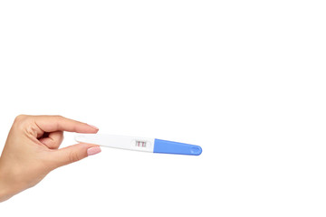 Positive pregnancy test with hand isolated on white background, two lines, copy space template.
