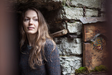 portrait of a young girl at the stone wall