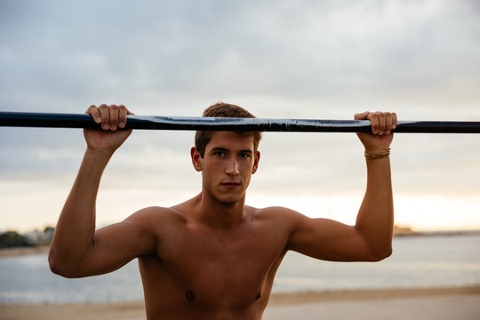 Young man training on bars.