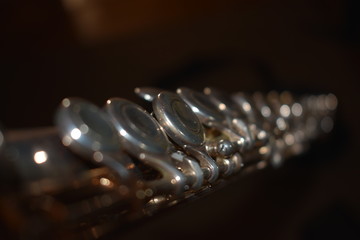 Close-up of a flute, showing the keys with a bokeh effect