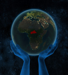Central Africa on night Earth in hands in space