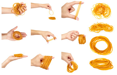 set of different Yellow rubber bands close up with hand isolated on white background