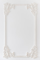 Decoration molding frame item made of white plaster. Relief stucco interior