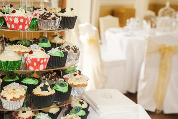 Colourful cupcakes at an event presented on a cake stand.