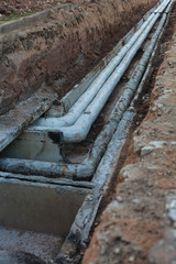 Old, Soviet time water pipelines after excavation, damaged asbestos coating