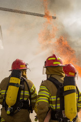 Some firemen fighting a great fire. Firefighters doing some training.