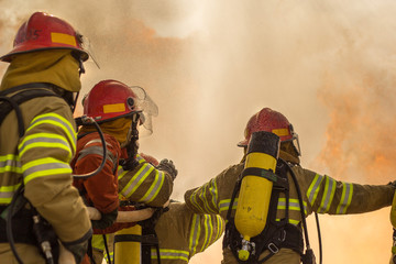 Some firemen fighting a great fire. Firefighters doing some training.