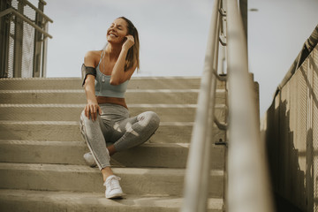 Young female runner resting on the stairs