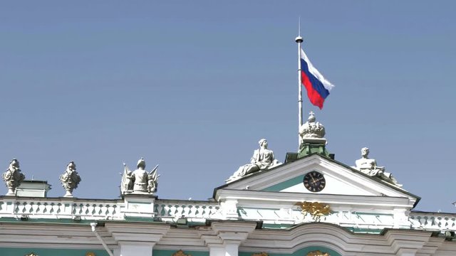 Saint Petersburg, Russia - August,2018: Russian flag waving above State museum, Winter palace, Hermitage.