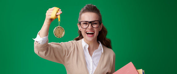 happy modern student woman with books showing medal