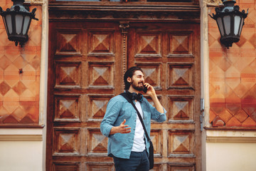Handsome businessman talking on the phone on the street
