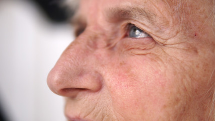 Close up of old thoughtful woman eye