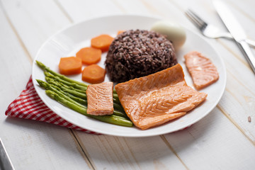 Health food concept, salmon with rice and vegetable on wood background