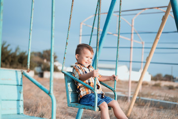 Child on a swing near the sea