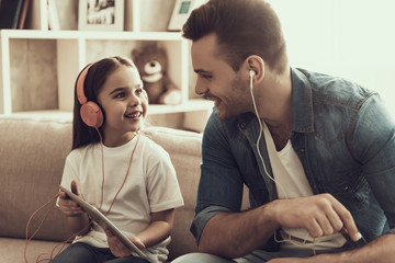 Young Smiling Man and Little Girl Listening Music