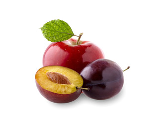 Red apple with leaf  and  plums on white background