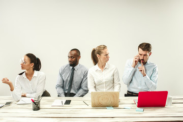 Young african and caucasian men and women sitting at office and working on laptops. The business,...