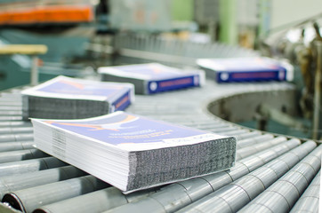 Print shop (press printing) - Finishing line. Post press finishing line machine: cutting, trimming, paperback and binding