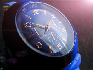 Wrist watch of blue color close-up on a gray background.