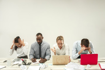 Young african and caucasian men and women sitting at office and working on laptops. The business,...