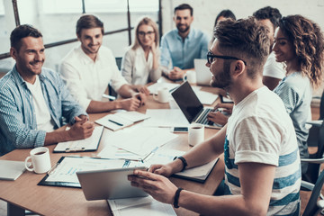 Young Smiling Business People on Meeting in Office