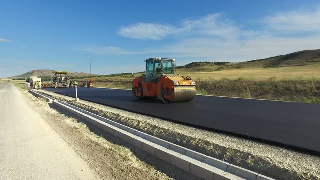 Road construction. Road roller doing repair and paving of streets, Building s New Road with Road Repair
