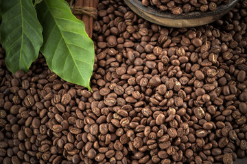 Cup of coffee, bag and scoop on old rusty background