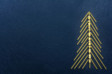 Christmas tree made with italian spaghetti on a slate background.