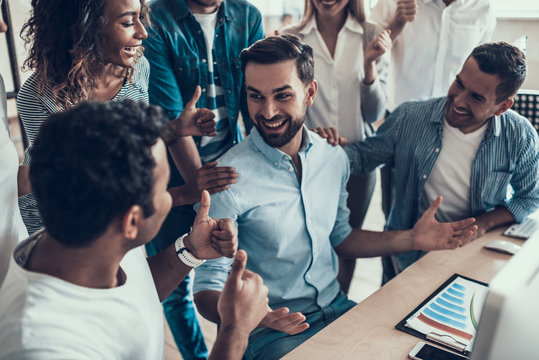 Successful Business Team Congratulating Colleague