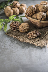 Fototapeta na wymiar Walnuts in wooden bowl. Whole walnut on table