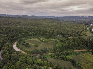 Fototapeta na wymiar Path through the green forest and countryside of Thailand, Top view aerial photo from drone.