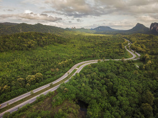 Fototapeta na wymiar Top View of Rural Road, Path through the green forest and countryside of Thailand, Top view aerial photo from drone