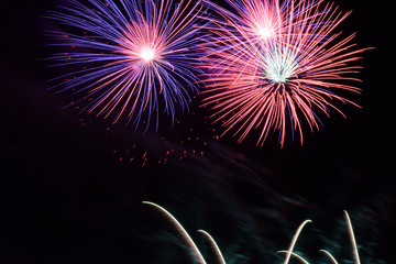 Fototapeta na wymiar beautiful colorful fireworks in the night sky, firework display for celebration by night