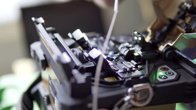 fiber optic fusion splicer working in field.  Fast internet technology development