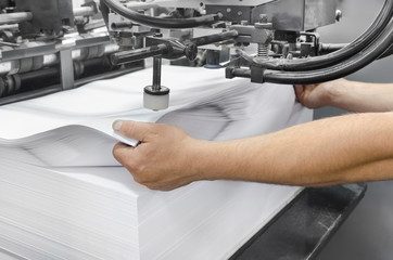 Print shop, preparing Large White Papers for Print at the Printing Machine