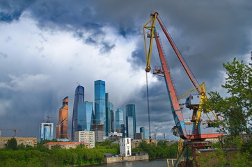 Crane on the river, against a background of skyscrapers