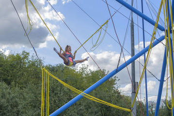 Girl bungee jumping in trampoline
