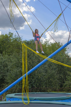 Girl Bungee Jumping In Trampoline