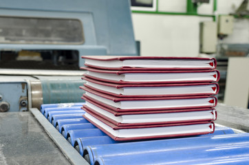 Book, magazine, production line into press plant house. Automatic assembly line, selective focus...