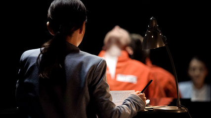 Female prosecutor interrogating suspect in criminal case, crime investigation