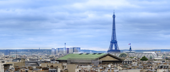 Aerial view of Paris, with the Eiffel Tower over roofs of Madeleine and Grand Palais