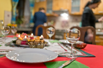 Empty plate with cutlery on the Christmas table.