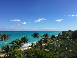 Fototapeta na wymiar Beautiful ocean view from the balcony. Palm trees, ocean, Atlantic coast of Cuba