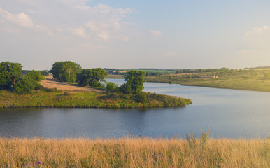 Sunny summer landscape with river,fields,green hills and trees.Tula region,Russia. 
