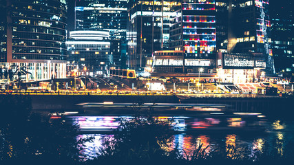 Obraz premium Night scene. Urban landscape. Skyscrapers and lights. Photo format - 16:9.